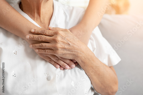 Young and senior woman holding each other hands togetherness concept. Elderly care and protection with love from grandchild.