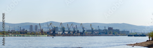 Panorama river Yenisei Siberia. Port docks in the city of Krasnoyarsk. Loading cranes