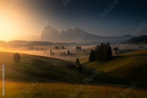Misty sunrise in the Dolomites mountains on a summer morning 