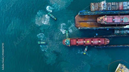 Tug boat drag pull cargo ship from dry dock concept maintenance service