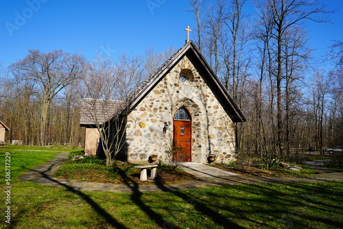 Historical old vintage abandon mini stone church stands enclosed around a forest out on the countryside in Wisconsin.