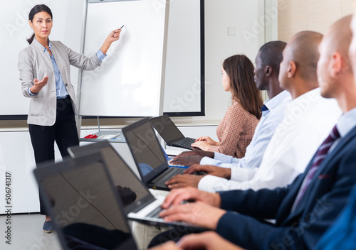 Female speaker giving talk on corporate business meeting in meeting room