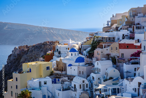 Village with greek white architecture on the sea cliff. Oia streets on Santorini, Greece.