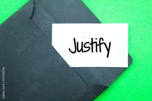 black envelope and white paper with the word Justify