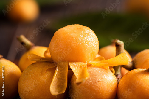 close up of peeled loquat fruit on wooden table