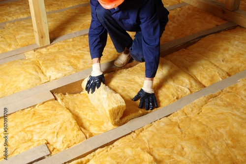 Construction worker thermally insulating house