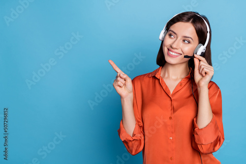 Portrait of attractive trendy cheerful girl help desk service showing copy space isolated over bright blue color background