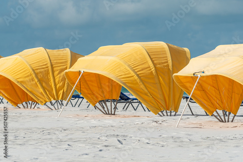 Yellow cabana and lounge chairs on the beach