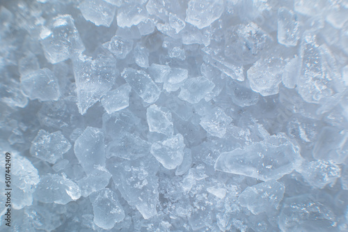 Coarse white iodized salt. Detailed background texture Macro close-up. Salt crystals of different sizes