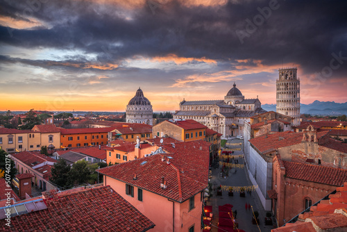 Pisa, Italy old town skyline with the cathedral and tower at dusk.