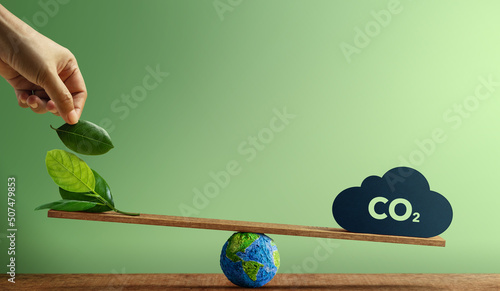 Carbon Neutral and ESG Concepts. Carbon Emission, Clean Energy. Globe Balancing between a Green leaf and CO2. Sustainable Resources, Concern about Environmental. Plant a Tree Sign