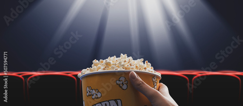 Woman eating popcorn at the cinema