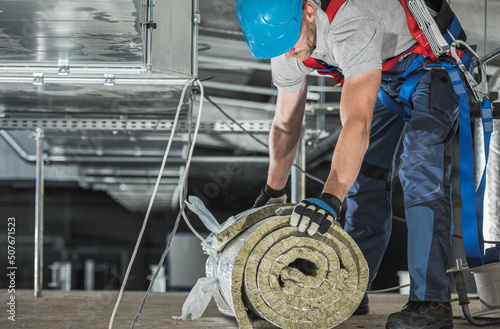 Worker with Piece of Mineral Wool Insulation