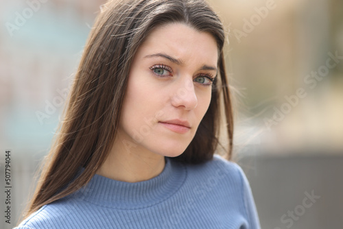 Angry and suspicious woman looking at camera