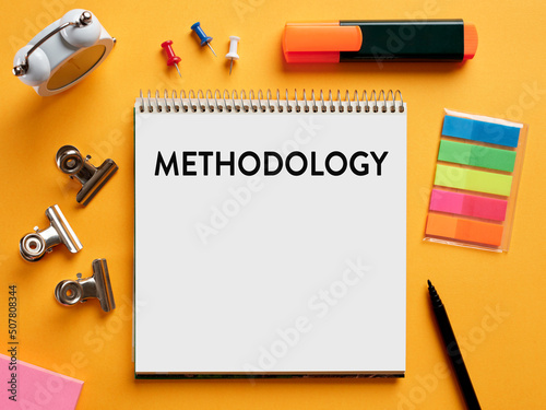 The word methodology written on a notebook on business office desktop.