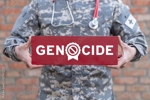 Concept of stop genocide and mass repression. Victims of crime of genocide. Prevention of crime of genocide. Military doctor holding of red banner of end the genocide.