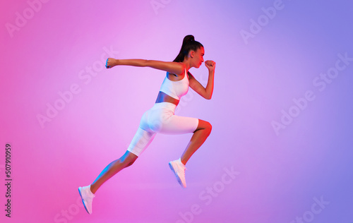 Sporty Lady Running In Mid Air Over Pink Neon Background