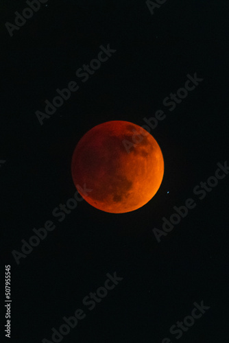 full blood moon with red color and star on the side, lunar eclipse