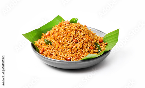 South Indian Traditional Puliogare, Puliodharai or tamarind rice on a banana leaf, isolated. Temple meal