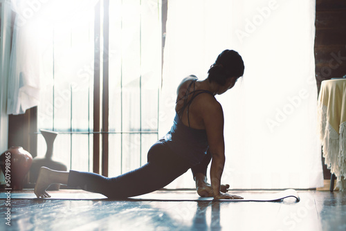 Portrait of gorgeous young woman practicing yoga outdoor. Beautiful girl practice cobra asana in class.Calmness and relax, female happiness.Horizontal, blurred background