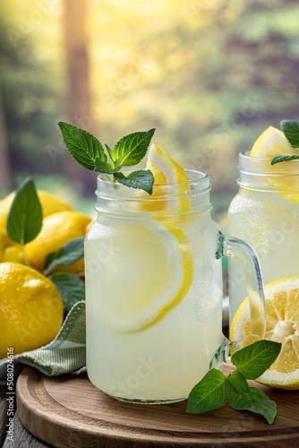Glass of lemonade with mint and lemons