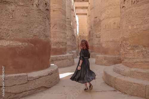 Woman between the pillars in the temple of Karnak in Luxor.