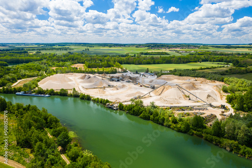 Aerial view of sandpit and factory plant producing sand materials for construction industry. Aerial view of the granite - gravel pit. Equipment for processing and crushing stones. 