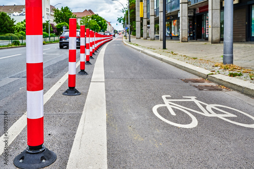 Separated bike lane on a main street in Berlin to improve road safety at the expense of parking lane.