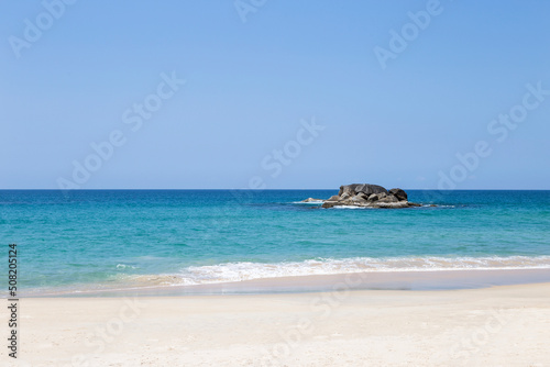 Clean sandy beach with beautiful blue sea and clear sky, tropical beach in south of Thailand, nature background