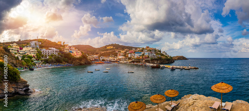 Panorama of Harbour with vessels, boats, beach and lighthouse in Bali at sunrise, Rethymno, Crete, Greece. Famous summer resort in Bali village, near Rethimno, Crete, Greece.