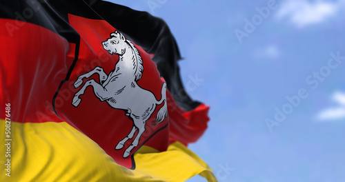 The flag of Lower Saxony waving in the wind on a clear day.