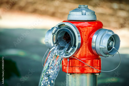 red fire hydrant leaking water