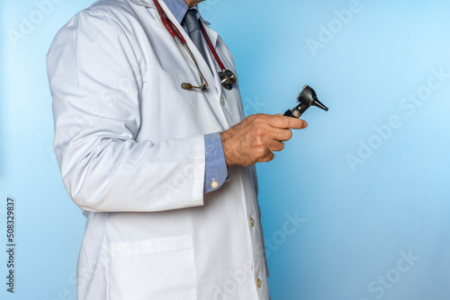 doctor with an otoscope in his hand
