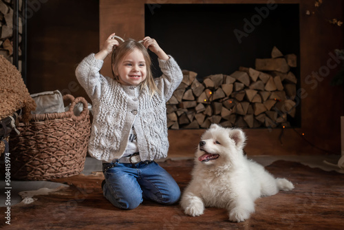 Nicole. Girl and samoyed husky dog. Home