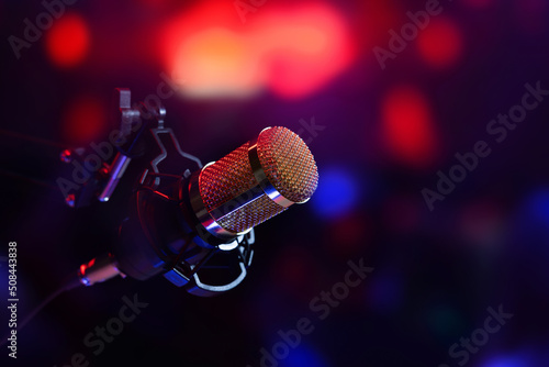 studio microphone in neon lights. sound recording equipment