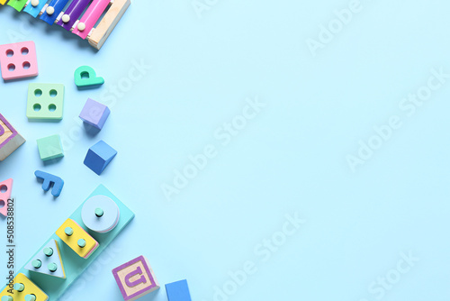 Children building blocks on blue background