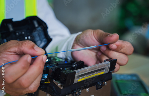  template Technician Fiberoptic Fusion Splicing. Worker connecting for Cable Internet signal and Wire connection with Fiber Optic Fusion Splicing machine,fiber optic cable splice machine in work