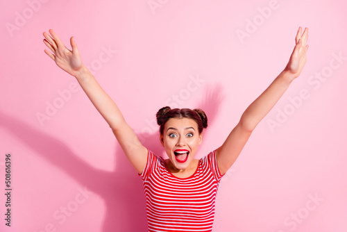 Photo of excited pretty lady dressed striped t-shirt smiling rising arms isolated pink color background