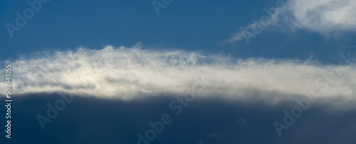 Rain clouds and stratus on blue sky background.