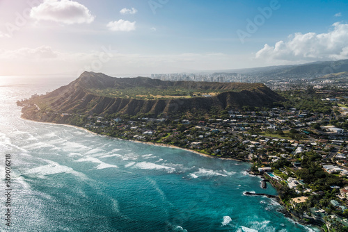 Aerial view of Diamond Head Mountain , volcanic tuff cone and city buildings in background, Honolulu, Oahu Island. Light effect applied