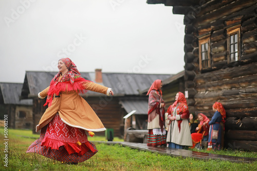 Traditional Slavic rituals in the rustic style. Outdoor in summer. Slavic village farm. Peasants in elegant robes.