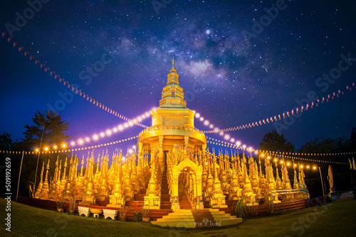 Scenery of 500 golden pagoda with Milky Way in the sky in Thailand.