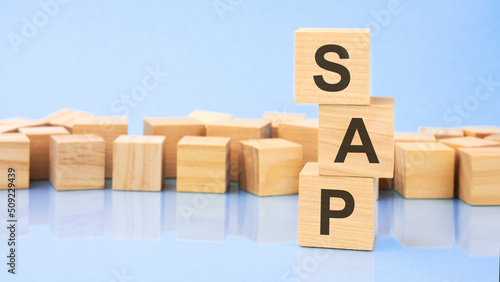on a bright blue background, light wooden blocks and cubes with the text sap