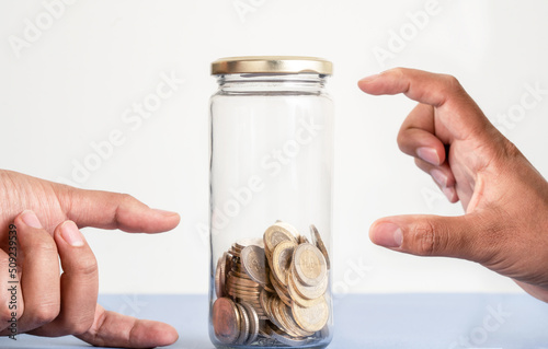 Close up photo hands pointing money collected and money missing as a symbol of point of view and crisis and opportinity. Concept of positive or negative thinking, pessimism or optimism