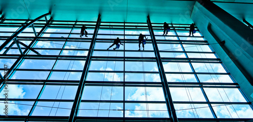 Extreme work. Cleaning the glass of a building at a height takes courage and challenges adrenaline 