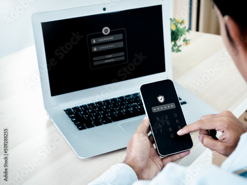 Two factor authentication or 2FA concept. Safety shield icon while access on phone with laptop for validate password, Identity verification, cybersecurity with biometrics authentication technology.