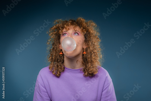 Girl is trying to blow a big bubble