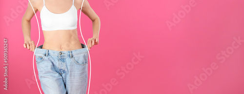 Closeup view of woman with slim body in oversized jeans on pink background, space for text. Banner design