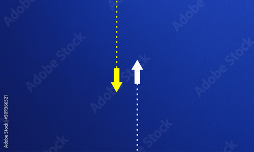 two opposite arrows on blue background. confrontation and differentiation concept. 