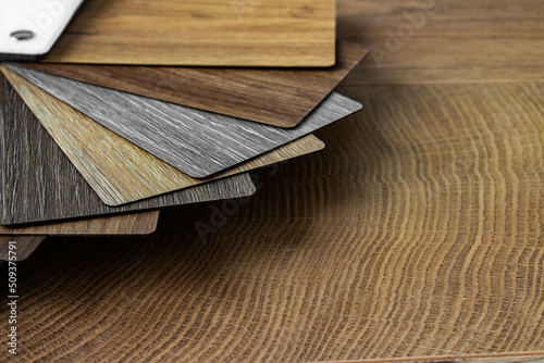 Sample of wood laminated chipboard for furniture design on wooden background with copy space. Color guide displaying a range of hues for use in interior design and decoration, for designers